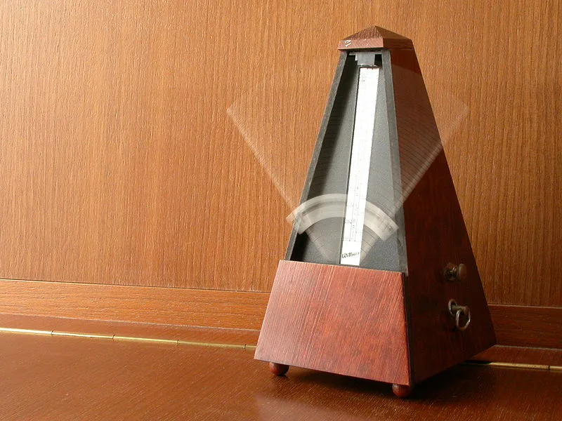 Classic wooden Wittner mechanical pyramid metronome used for keeping time during guitar practice