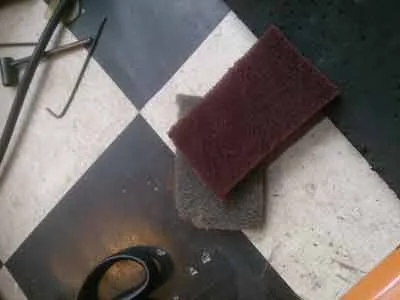 Using a Scotch-Brite pad to take down the gloss finish
