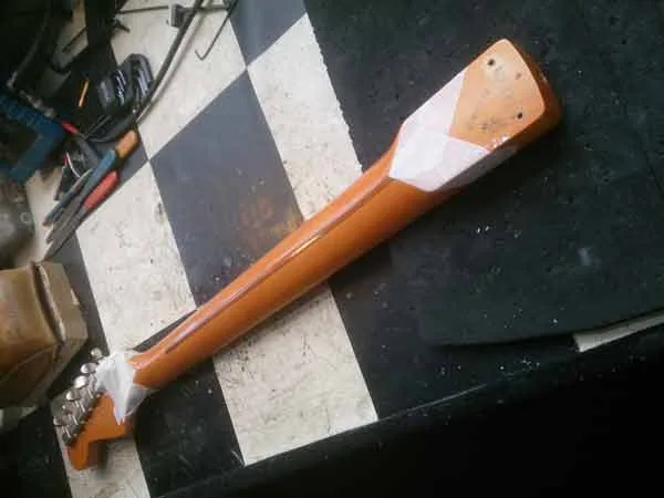 Wiping down the satin guitar neck midway through restoration