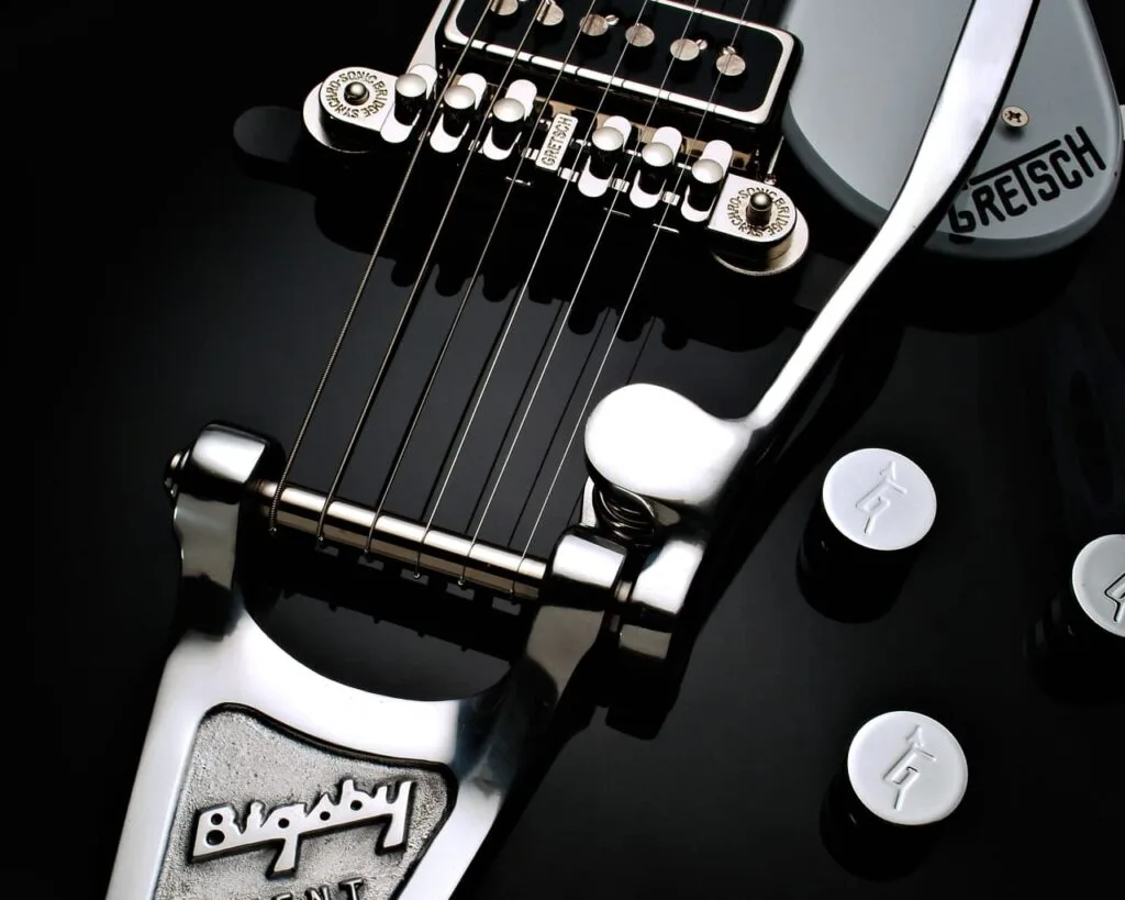 Close up view of the chrome bridge and tailpiece hardware on a Gretsch electric guitar