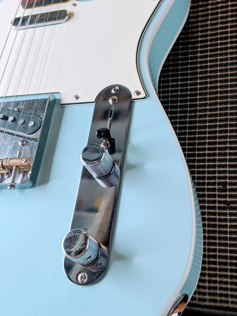 Blue Fender Telecaster electric guitar body detail during a daily practice session