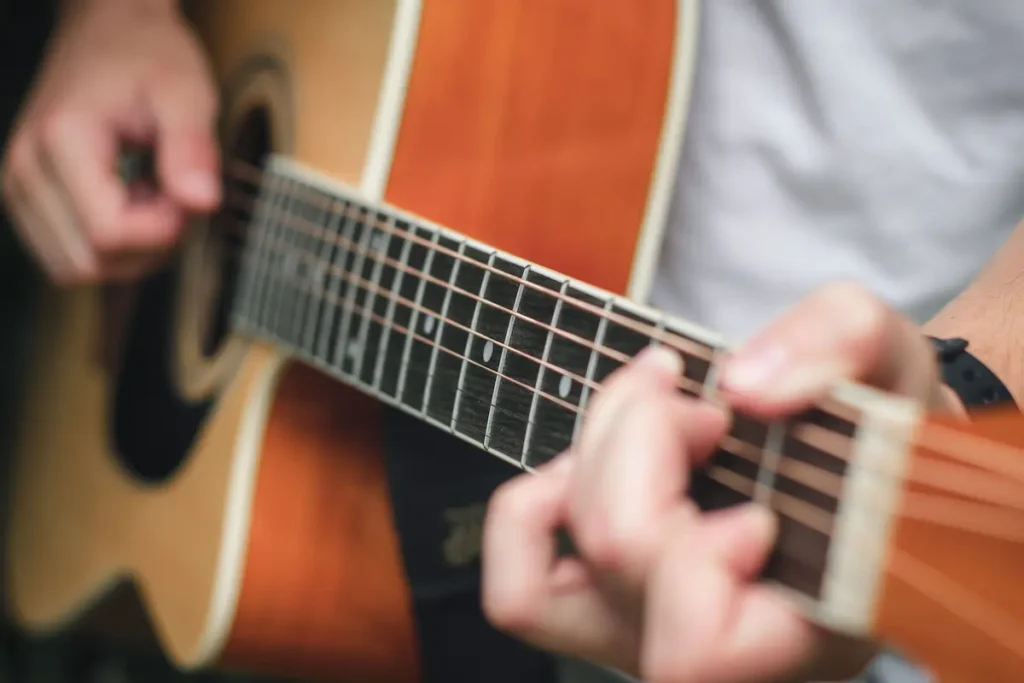 Playing Acoustic guitar