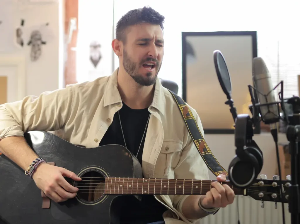 singing and playing guitar at the same time