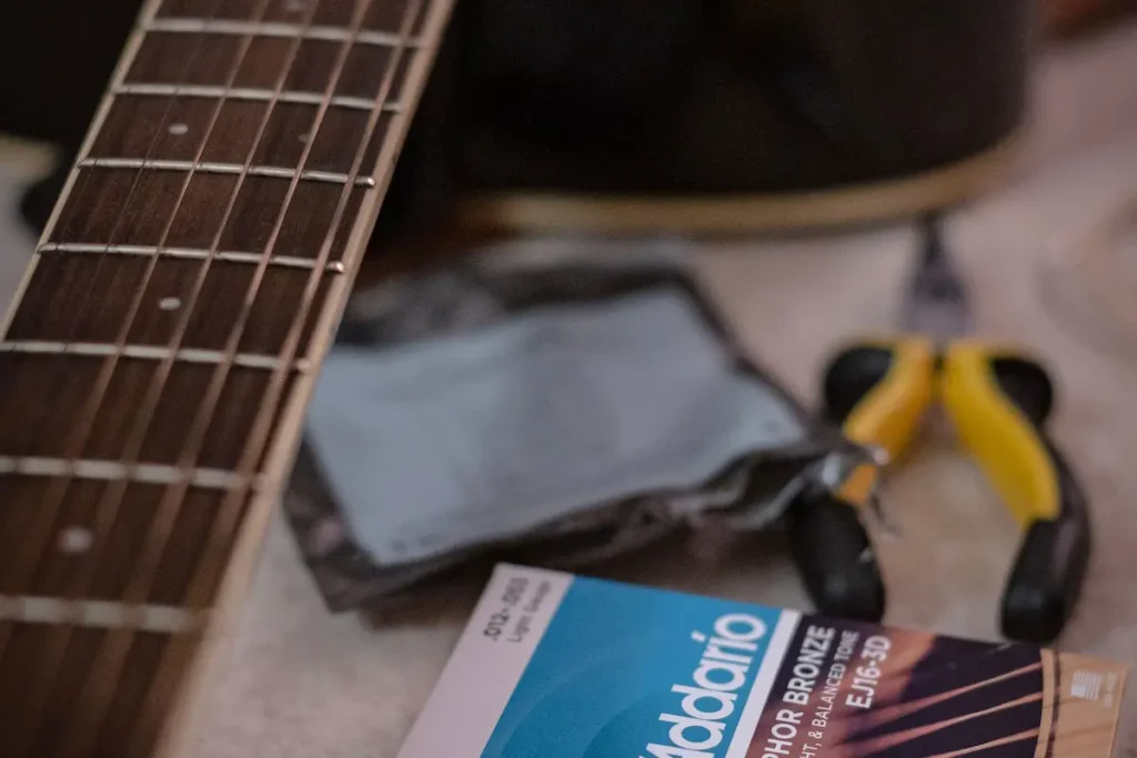 Guitar, new strings and guitar tools ready for guitar maintenance