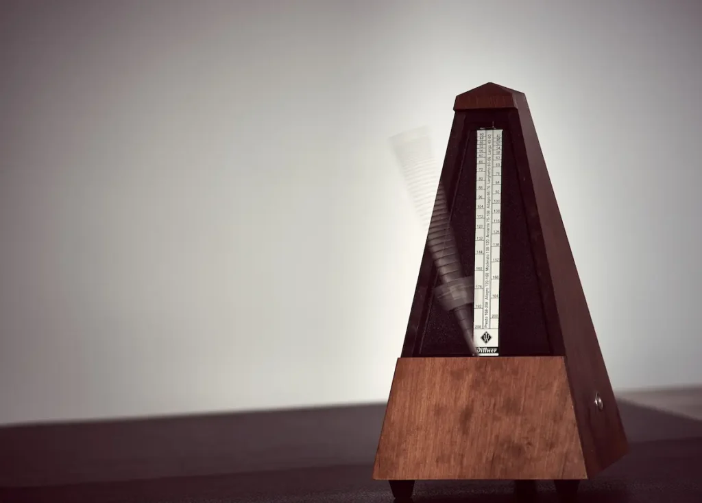 Analogue metronome sitting on a wooden table